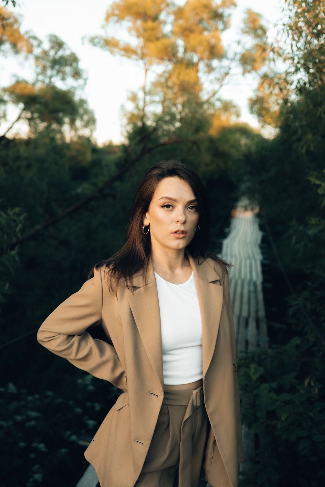 Tan blazer and wide trousers with a cream cropped top.