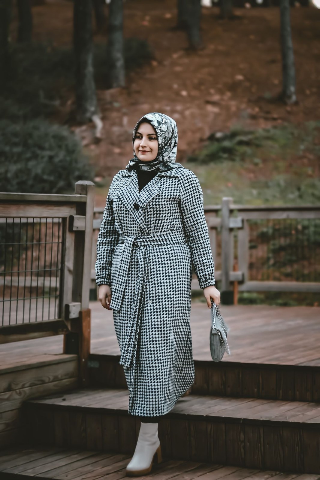 Grey-white gingham belted midi shirt-dress, patterned headscarf, white ankle boots and small silver bag.